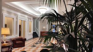 a living room with a couch and a plant at Radisson Blu GHR Rome in Rome