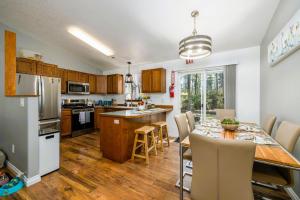 a kitchen and dining room with a table and chairs at Cozy 3-Bedroom Retreat with Fenced Yard, Games & BBQ- Pet Friendly in Coeur d'Alene +20 photos