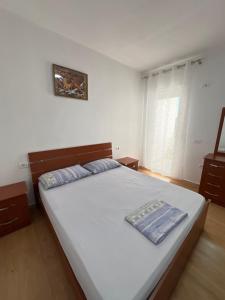 a bedroom with a large white bed in a room at Cameria in Durrës