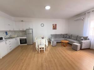 a living room with a couch and a table at Cameria in Durrës