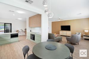 a kitchen and living room with a table and chairs at Granite Grove in Port Elliot