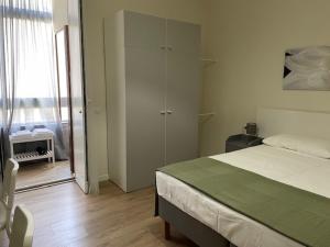 Łóżko lub łóżka w pokoju w obiekcie Il Mughetto