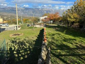 a fence in a field with mountains in the background at Casa Capanna in Bugnara