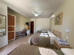 a bedroom with two beds and a ceiling fan at Ózera Hotel Fazenda in Prudentópolis +47 photos