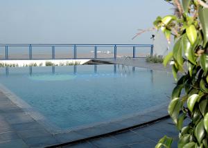 a large swimming pool with a bridge in the background at Auberge Oualidia Dream in Oualidia