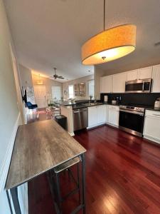 an empty kitchen with a large island in the middle at Modern comfort 2BR-2BA Retreat in Concord