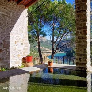 a house with a swimming pool with a view of the water at Casa MªÁngeles in Puebla de Arenoso