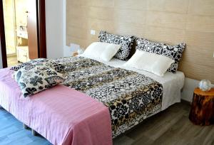 a bedroom with a large bed with pillows at B&B La Casa Bianca di Porto Conte in Porto Conte