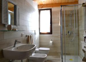 a bathroom with a sink and a toilet and a shower at B&B La Casa Bianca di Porto Conte in Porto Conte