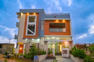 a house with lights on the front of it at Hampi Lake House in New Hampi