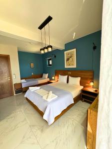 a bedroom with a large bed with blue walls at Armenopetra View Gerolimenas in Gerolimenas