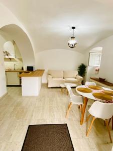 a living room with a table and a couch at Hanna Vendégház-Tállya in Tállya