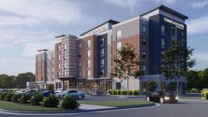 an architectural rendering of a hotel with cars parked in a parking lot at TownePlace Suites by Marriott Murfreesboro in Murfreesboro