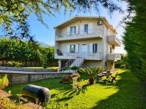 a large house with a lawn in front of it at Ana's House in Orikum