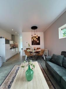 a living room with a green vase on a table at Lakeside Retreat at Veluwe in Nunspeet