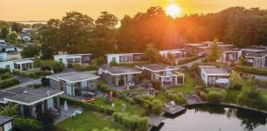 an aerial view of a house with a lake at Lakeside Retreat at Veluwe in Nunspeet