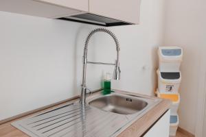 a kitchen with a sink in a small kitchen at Vacanze da Beppuccio Scoglitti in Vittoria +81 photos