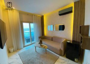 a living room with a couch and a table at Hayah Waterfalls Hotels in Alexandria
