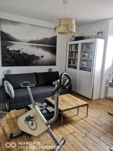 a living room with a couch and a table at chambres dans Maison individuelle 46 Rue de Luzel in Saint-Brieuc +5 photos