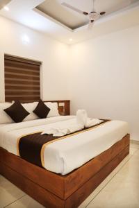 Ένα ή περισσότερα κρεβάτια σε δωμάτιο στο Thazhvaram Homestay