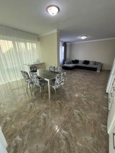 a living room with a table and chairs and a couch at Rare apartment in kojori in Tbilisi City