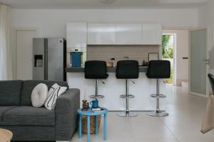 a living room with a couch and a kitchen at Villa Aurelia by Domus Mirus - Rooftop Cinema & Pool & 6 Minute Walk to Beach in Splitska