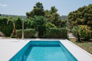a swimming pool in a yard with trees at Villa Aurelia by Domus Mirus - Rooftop Cinema & Pool & 6 Minute Walk to Beach in Splitska