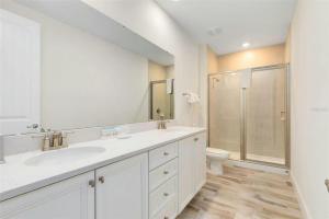 a white bathroom with a sink and a toilet at Margaritaville Florida Getaway in Orlando +57 photos
