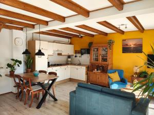 a kitchen and living room with a table and chairs at BijOpaenOma in Oosterend