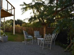 a group of chairs and a table in a yard at Ginger Lake Wilderness in Wilderness +12 photos