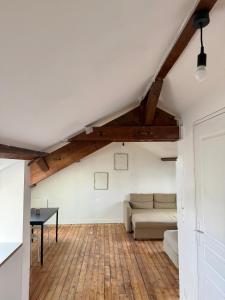 a living room with a couch and a table at Cosy Appartement proche de Paris in Villeneuve-Saint-Georges