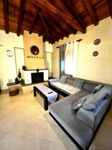 a living room with a couch and a table at The Fortress, beautiful and private house with top in Skiathos Town