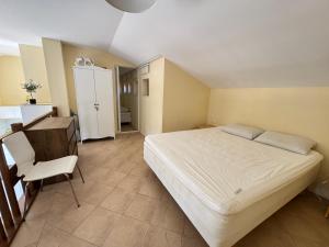 a bedroom with a bed and a desk and a chair at Santa Marina resort Sozopol - penthouse with amazing sea view in Sozopol +26 photos