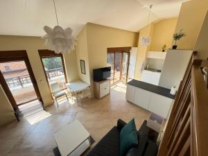 a living room with a couch and a kitchen at Santa Marina resort Sozopol - penthouse with amazing sea view in Sozopol