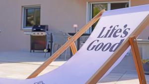a sign that says life is good sitting on a porch at Biba’s Place in Blagaj