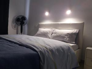 a bedroom with a bed with two lights on it at TUNERAS SUNSET Puerto Rico Apartment, Sea view, Pool, Perfect for sun lovers in Mogán