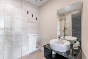 a white bathroom with a sink and a shower at Apartamentos Cubicos in Bronchales +20 photos