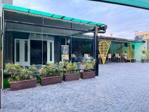 a patio with potted plants in front of a building at Ritro Plaza Hotel in Kampala