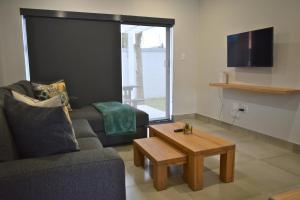 a living room with a couch and a coffee table at Luxury 2 bed York Retreat - Townhouse 3 - 1 on york in George