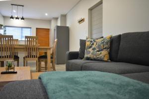 a living room with a couch and a table at Luxury 2 bed York Retreat - Townhouse 3 - 1 on york in George