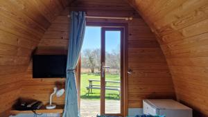 a window in a wooden room with a sliding glass door at Dinas in Llanbedr