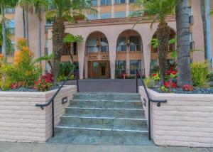 a staircase leading to a building with palm trees at 2 bed 2 bath penthouse condo with AC and Ocean Views in San Diego