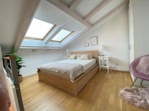 a bedroom with a bed and two skylights at Hidden Hideaway in Razvala