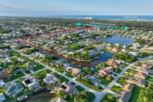 an aerial view of a suburb with houses and the water at Coastal Paradise Waterfront Pool Home in Bon Terra