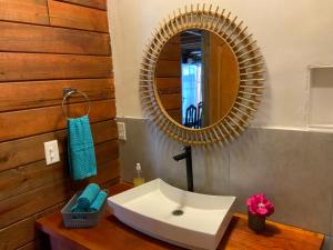 a bathroom with a white sink and a mirror at Peaceful Refuge in Quiete Bay in Bocas del Toro +30 photos