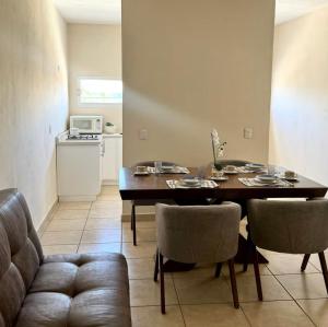 a living room with a table and chairs and a kitchen at JUCAR Place in Villa Hidalgo