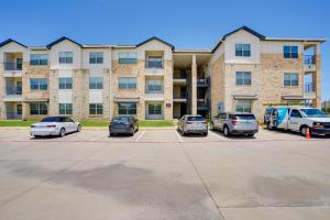 a parking lot with cars parked in front of a building at Pool Access, 1 Mi to Shops and Eats Crowley Rental in Crowley