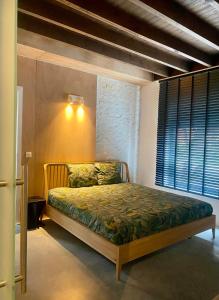 a bedroom with a bed in a room with a window at Hoeve DeKleinheide 1 in Dessel