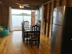 a dining room with a table and a refrigerator at Peaceful Refuge in Quiete Bay in Bocas Town