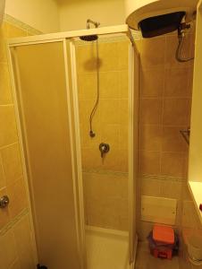 a shower with a glass door in a bathroom at L'Aragosta Guesthouse in Alghero +24 photos
